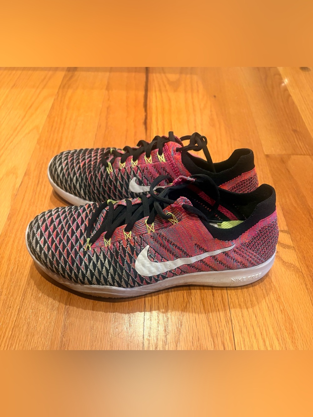 Nike Women’s Pink Black Flyknit Training Sneakers with White Swoosh